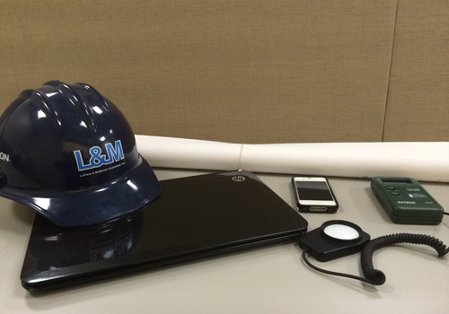 Lighting Controls Field Technician Services hardhat next to led lighting controls equipment